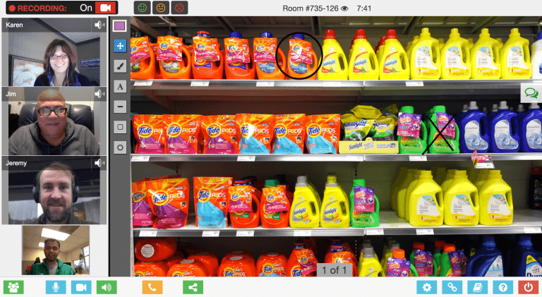 screen-shot-1 Video conference call with four participants on the left. Shelves filled with various laundry detergent products on the right.