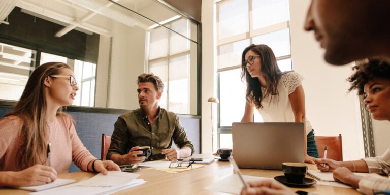 Market Dynamics- Innovating Insights with Generative AI in Market Research Team collaborating in a meeting room
