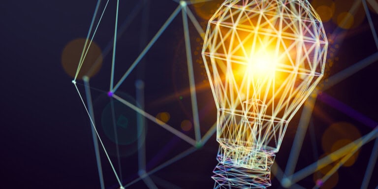 Abstract illustration of a glowing lightbulb composed of digital wireframe lines against a dark background, with geometric patterns and lens flare effects.