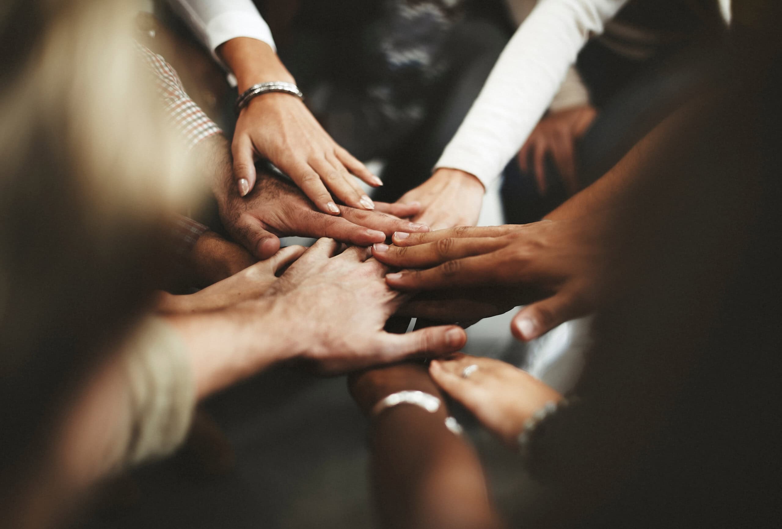Hands joined together in a team huddle